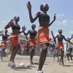 Fusion between culture and modernity as children dance in Kenyan refugee camp