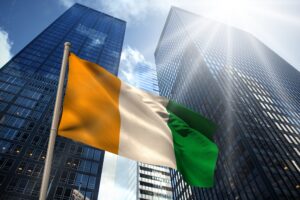 Ivory,Coast,National,Flag,Against,Low,Angle,View,Of,Skyscrapers